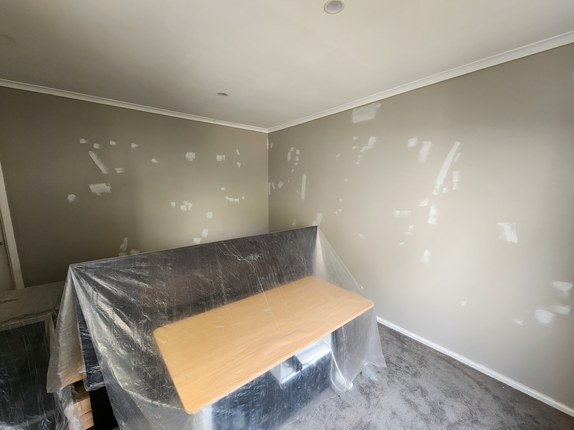 Walls fully prepped with imperfections filled and sanded, and furniture protected with drop cloths before painting