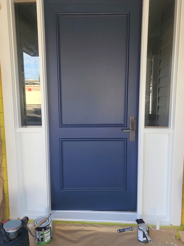 Front door freshly repainted in a deep navy finish